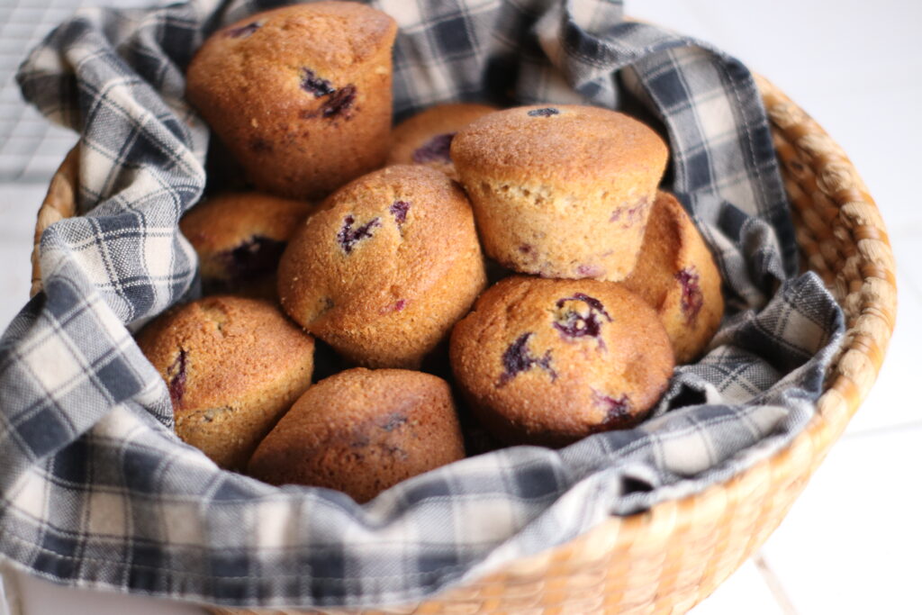 a basket of blueberry muffins