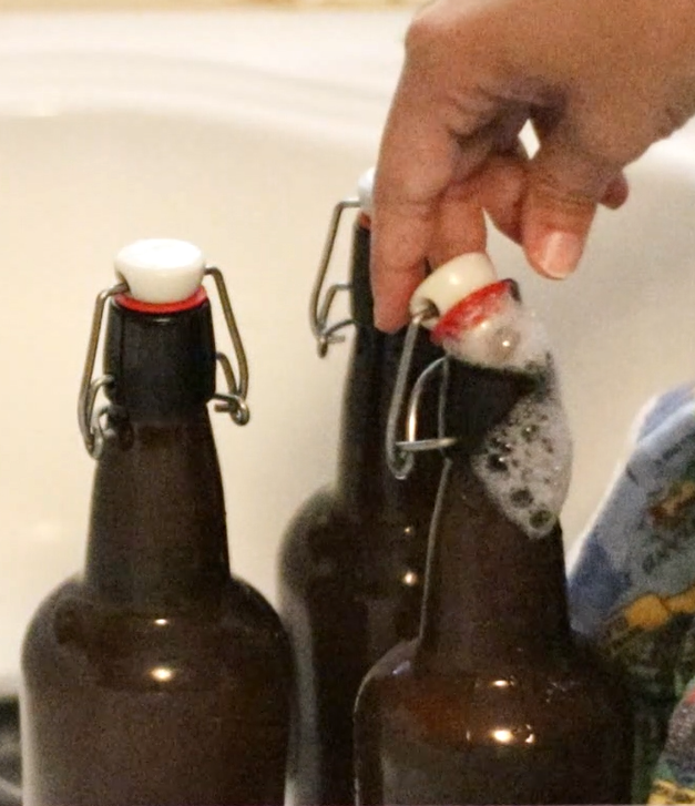 fizzy ginger beer coming out of a brown glass bottle