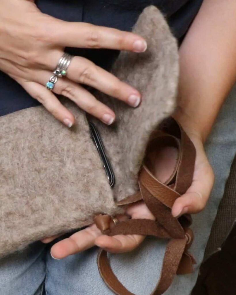 adding a simple leather strap onto the wet felted bag