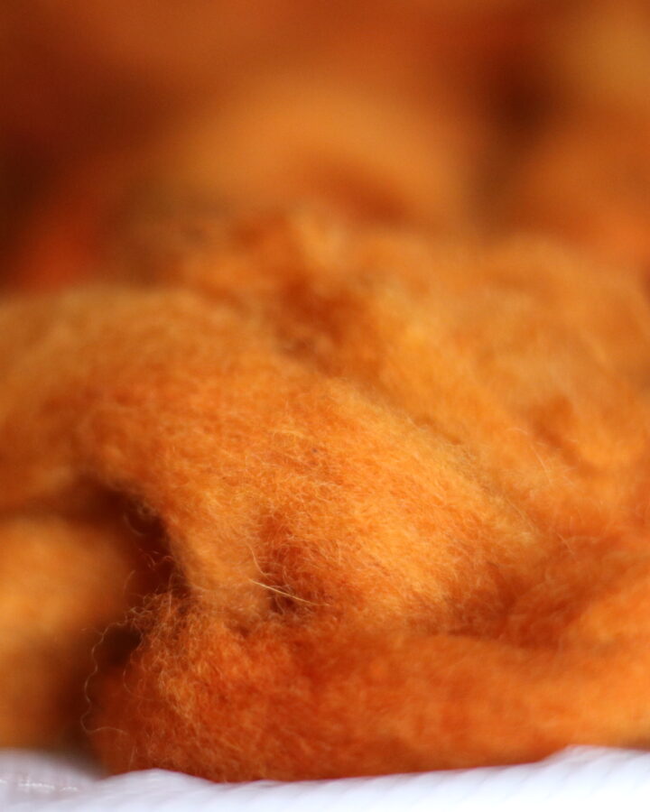 orange wool dyed with coreopsis flowers