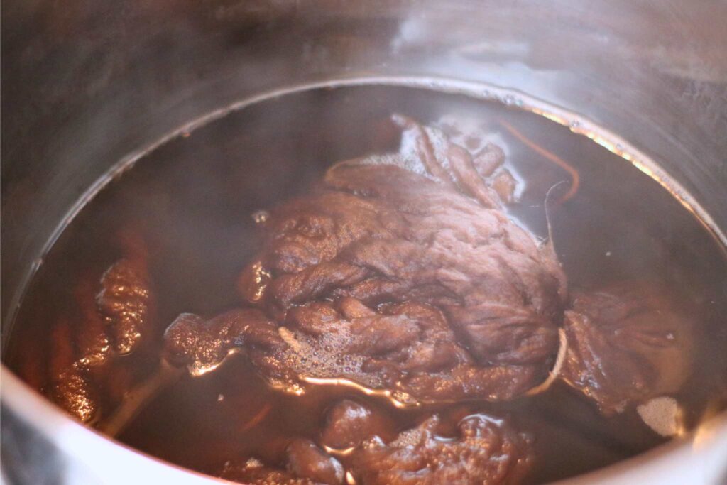 a pot of cotton sliver and brown dye 