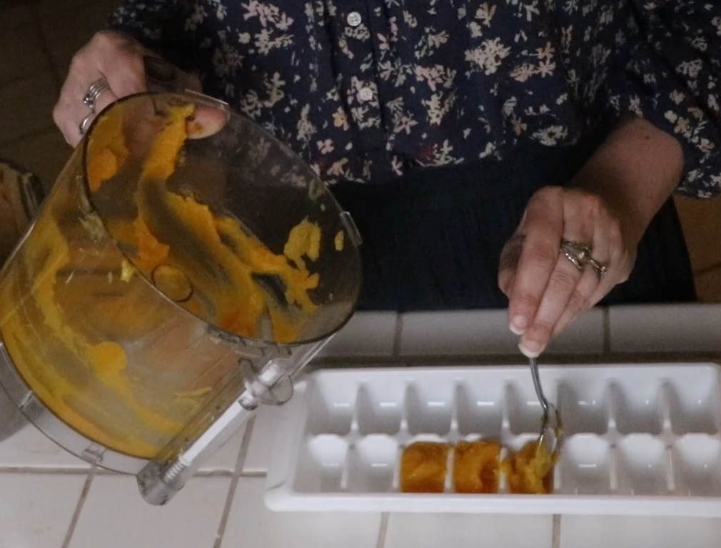 pumpkin chocolate chip cookies hands spooning excess pumpkin puree into an ice cube tray