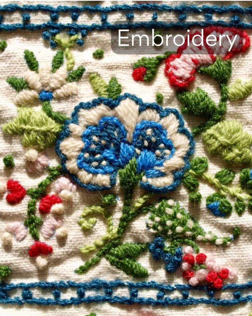 a cloth embroidered with wool yarn in a floral design.