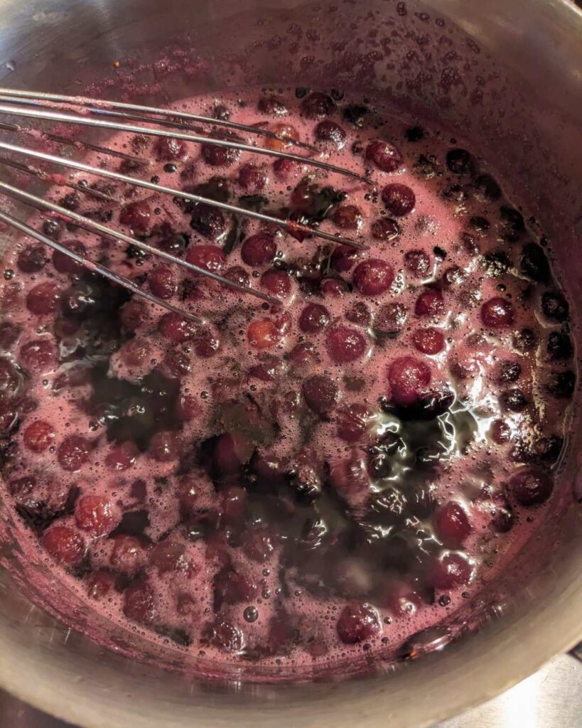 a pot of simmering blueberries