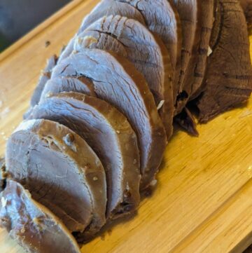 sliced corned venison on a cutting board