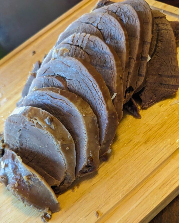 sliced corned venison on a cutting board
