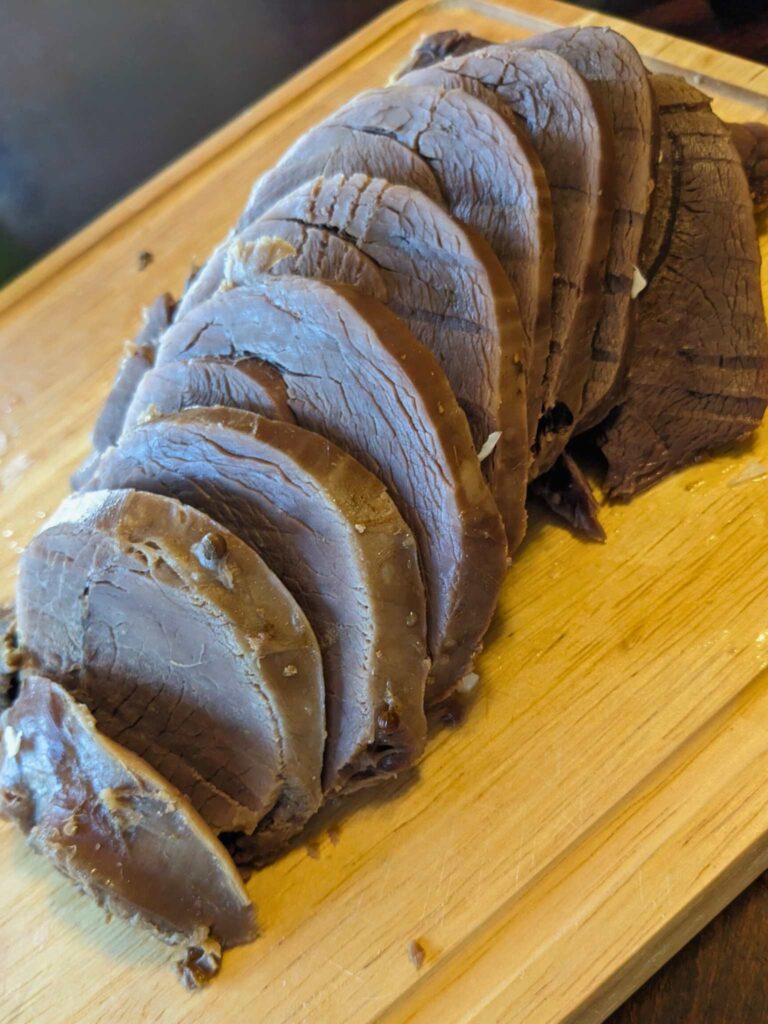 sliced corned venison on a cutting board