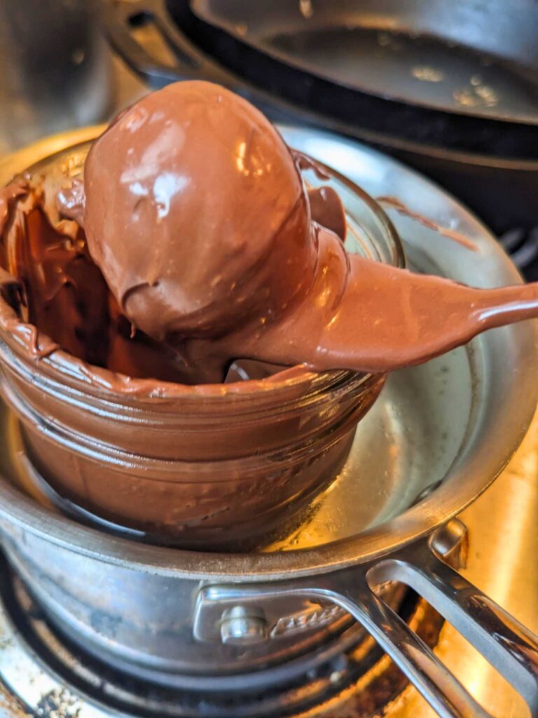 dipping peanut butter balls in melted chocolate.