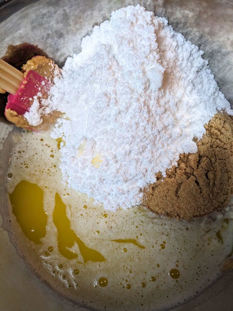 a bowl of powdered sugar, graham cracker crumbs, peanut butter, and melted butter.