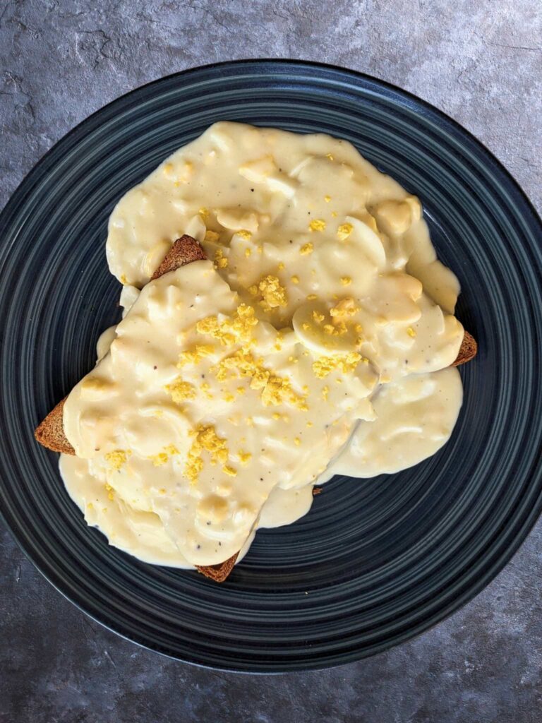 a plate of creamed eggs on toast