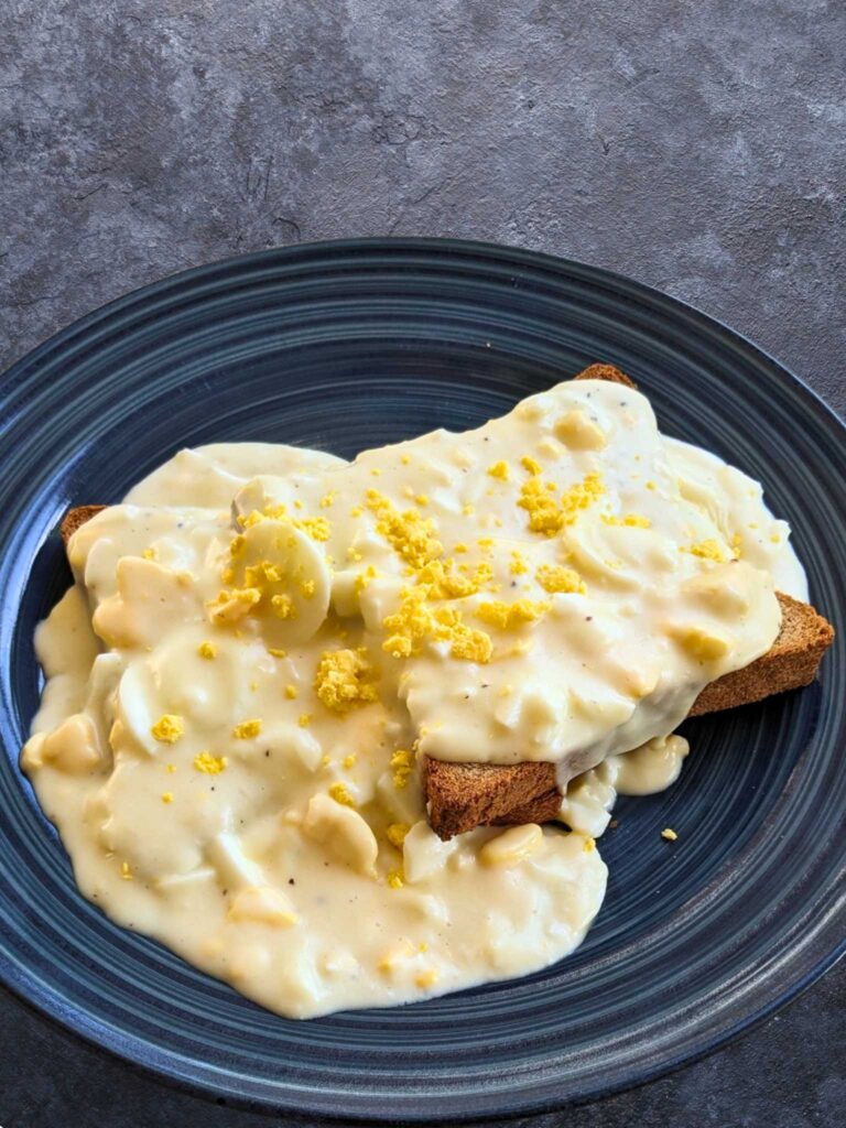 a plate of creamed eggs on toast