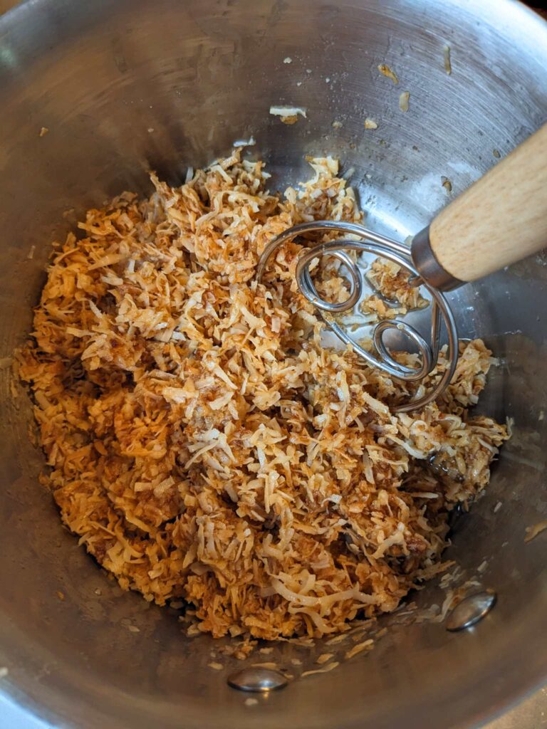 stirring the date paste into the coconut mixture