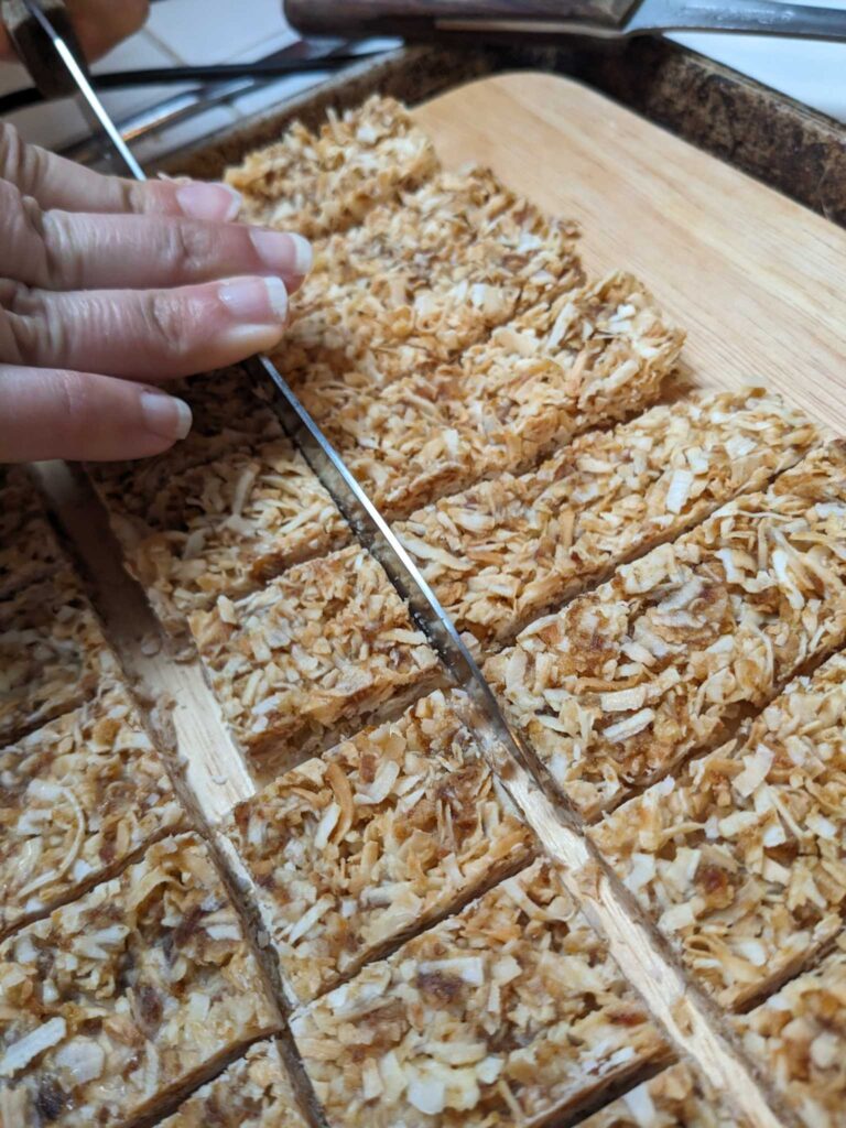 cutting the frozen almond joy filling into rectangles