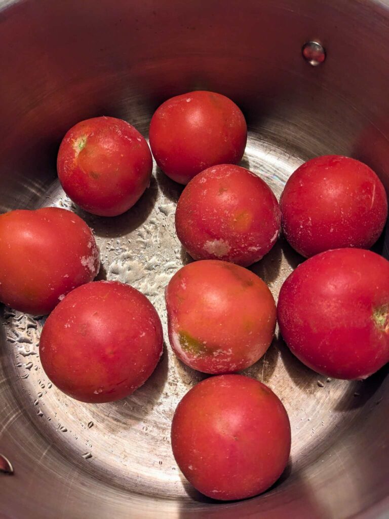 frozen whole tomatoes in a pot
