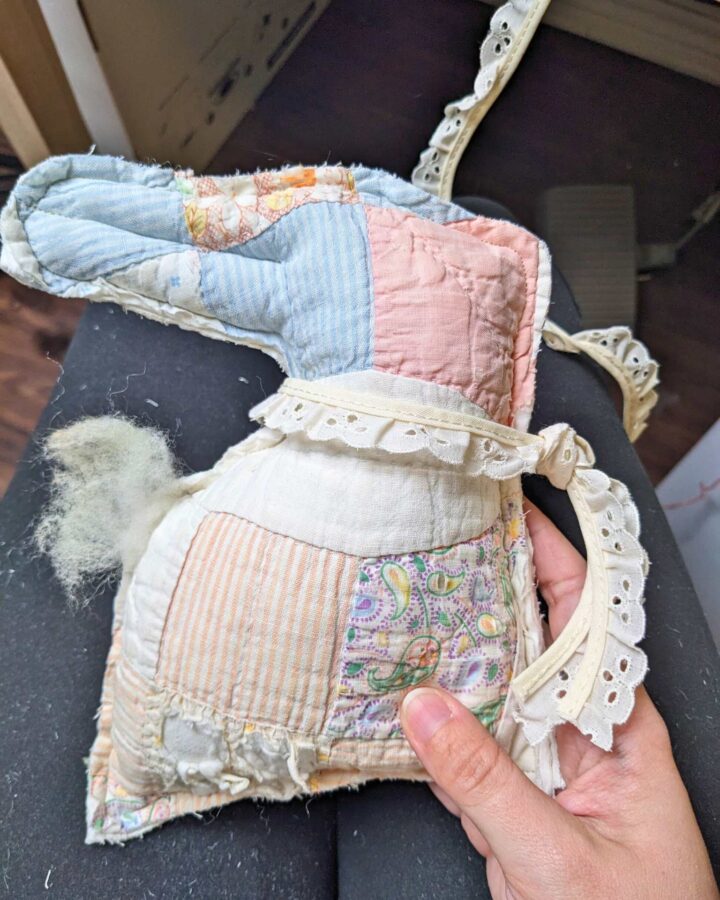 a stuffed bunny made from a tattered old quilt