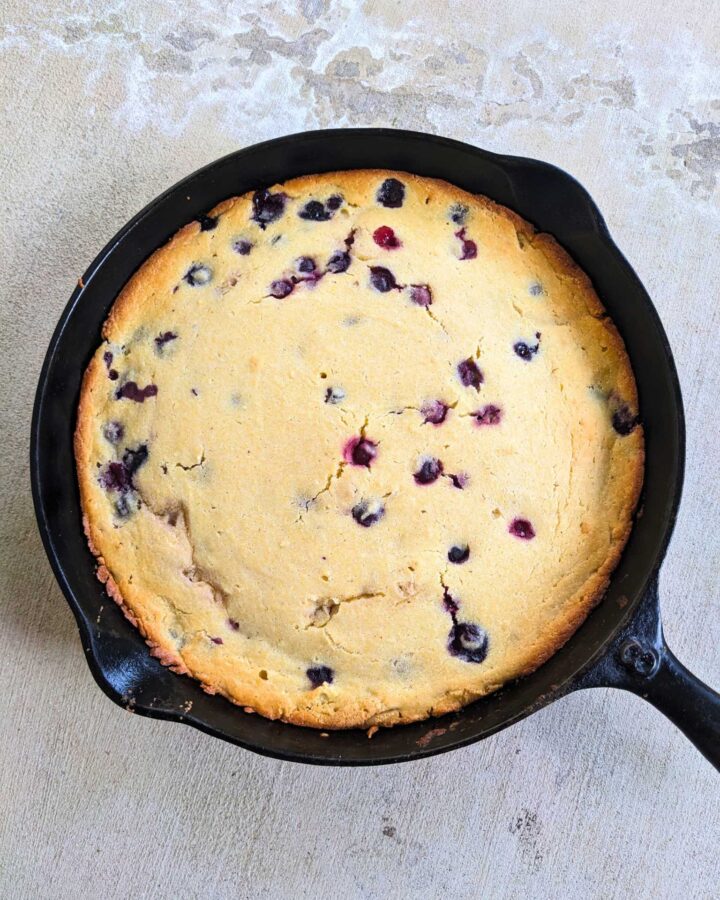 blueberry cornbread in a cast iron skillet