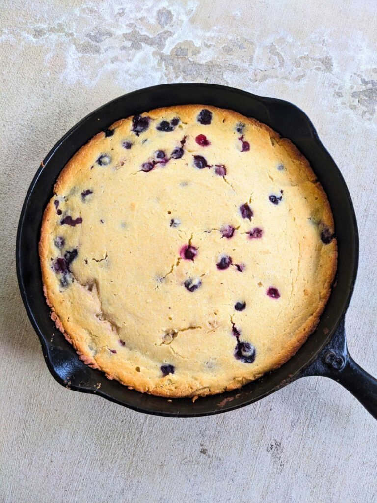blueberry cornbread in a cast iron skillet