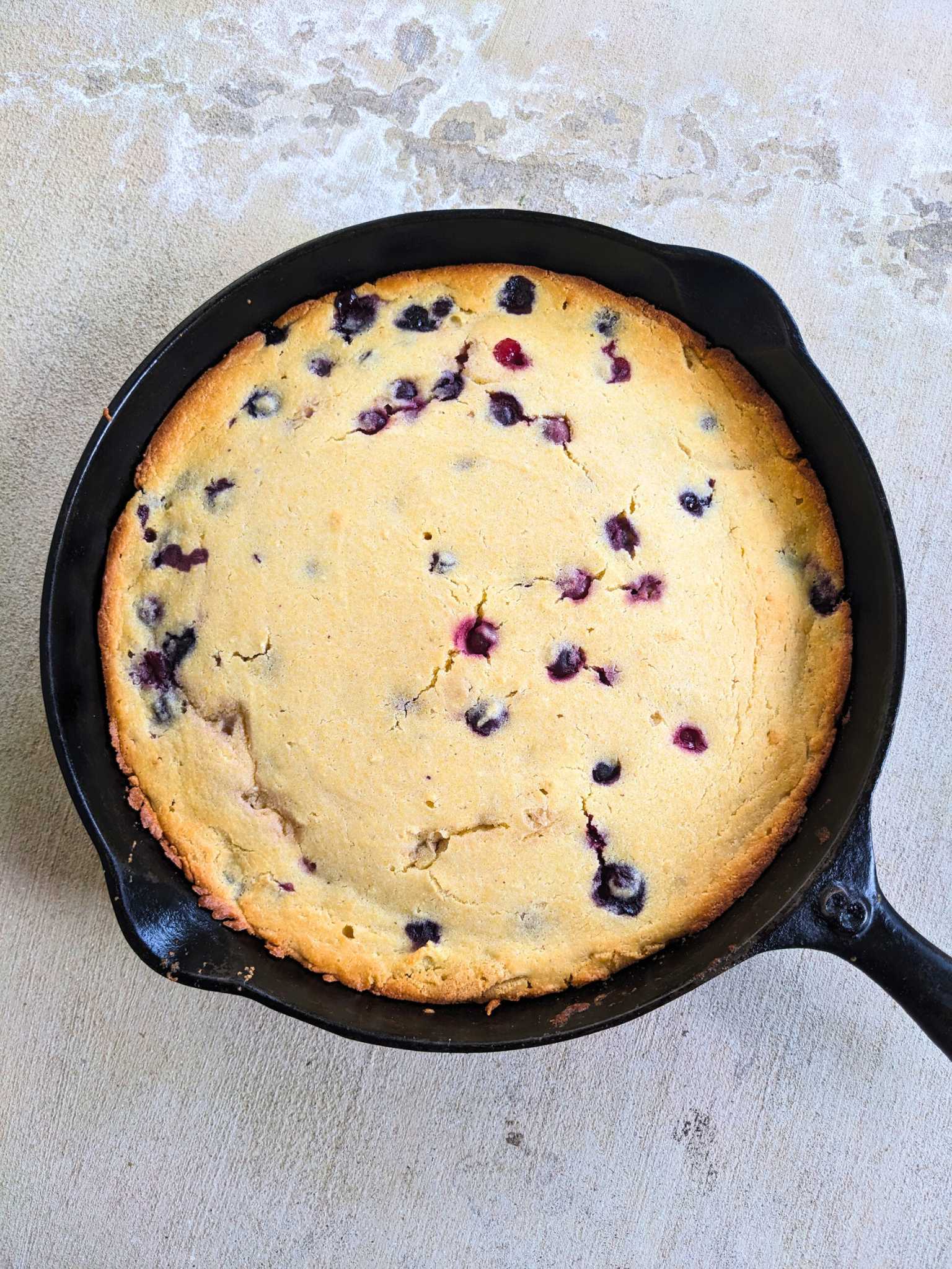 blueberry cornbread in a cast iron skillet
