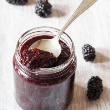 an open jar of seeded blackberry jam